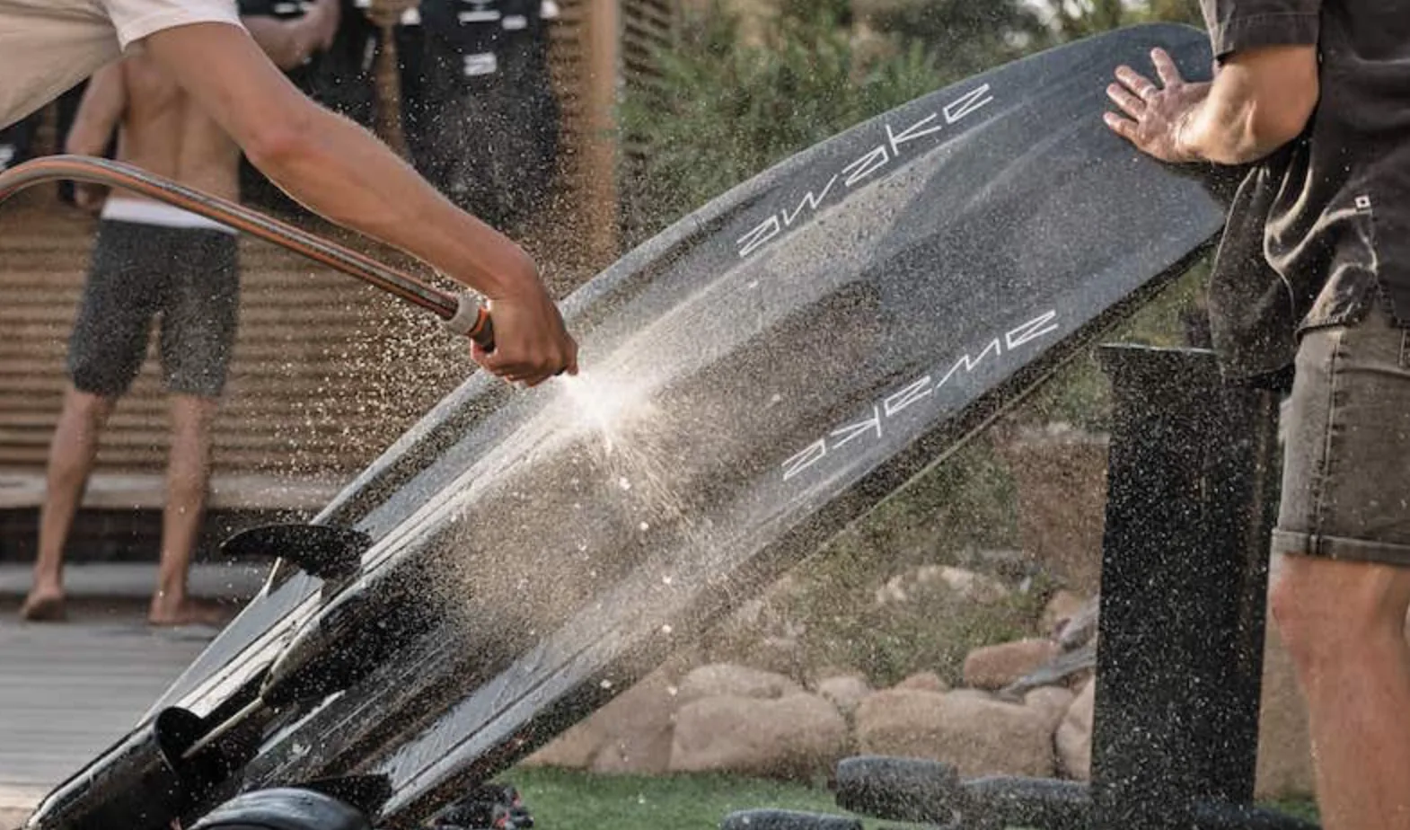 An Awake board being rinsed with fresh water after riding